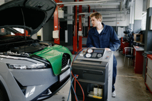 Image showing AC service machine connected to a vehicle with technician