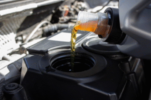 Image of oil being poured into an engine